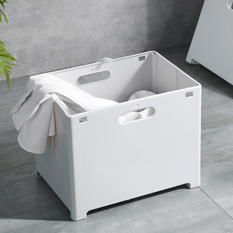 Wall bracket being screwed into bathroom wall during installation of the wall mounted hamper
