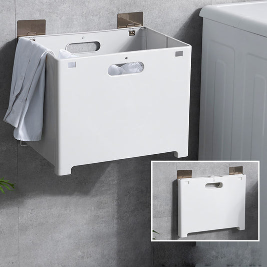 White wall mounted laundry hamper with flat shelf installed on a small bathroom wall
