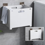White wall mounted laundry hamper with flat shelf installed on a small bathroom wall