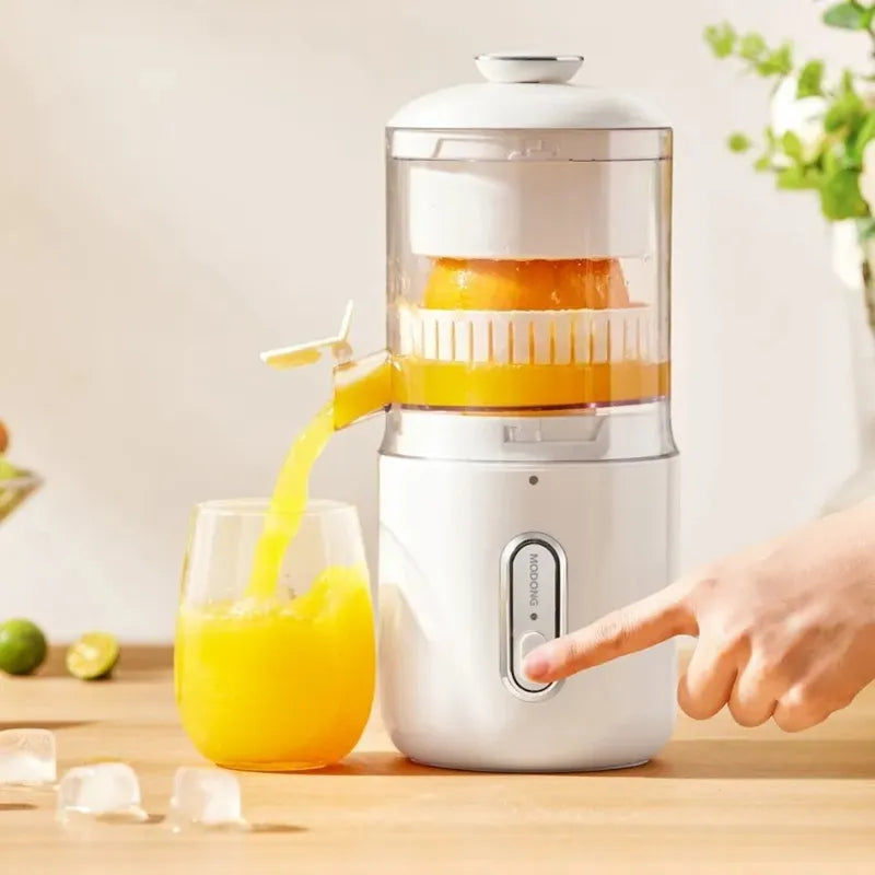 Wireless portable electric juicer pouring fresh orange juice into glass