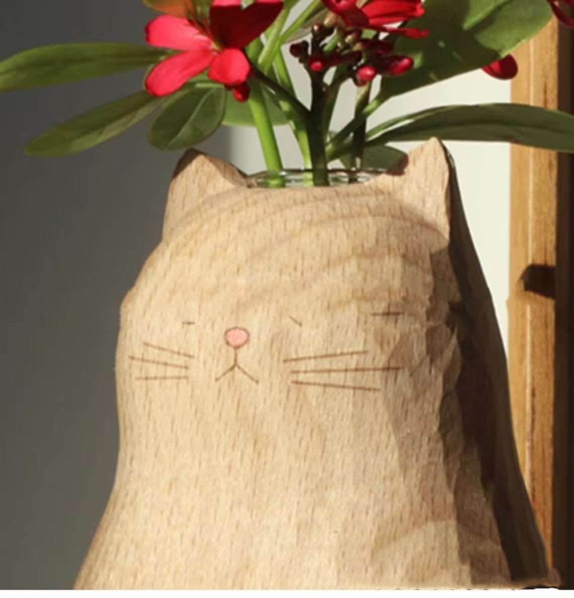 Empty handmade wooden cat vase with heart carving detail