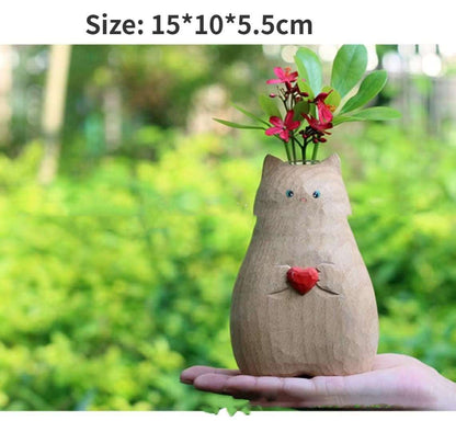 Wooden cat shaped vase decorated with green leaves