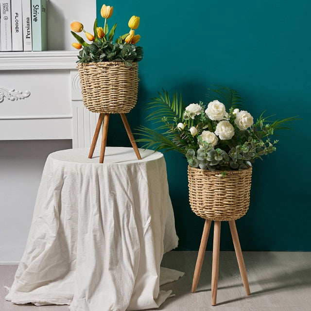 Natural straw floor planter styled in a boho bedroom corner with a dried flower arrangement
