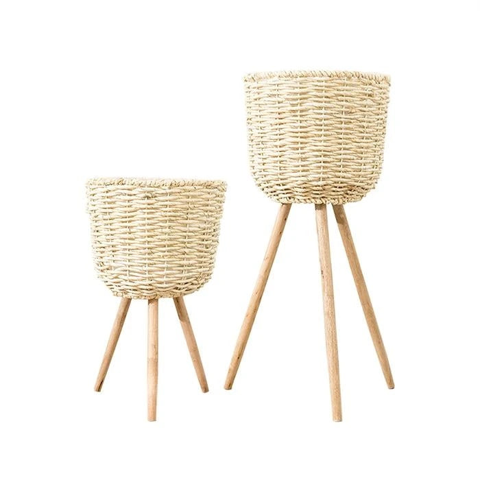 Medium woven straw floor planter holding a dried pampas grass arrangement in a bright hallway
