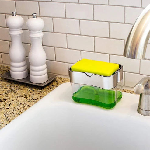  Woman using soap dispenser at kitchen sink