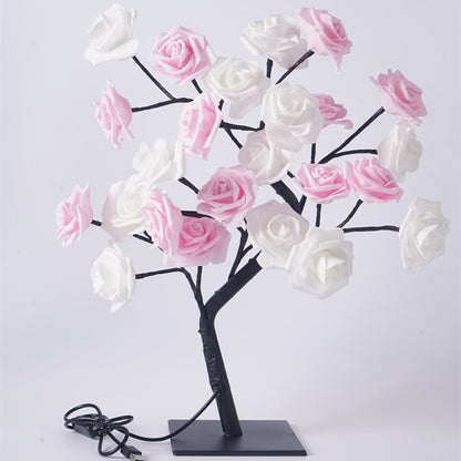 Yellow rose tree night light warm glow close up